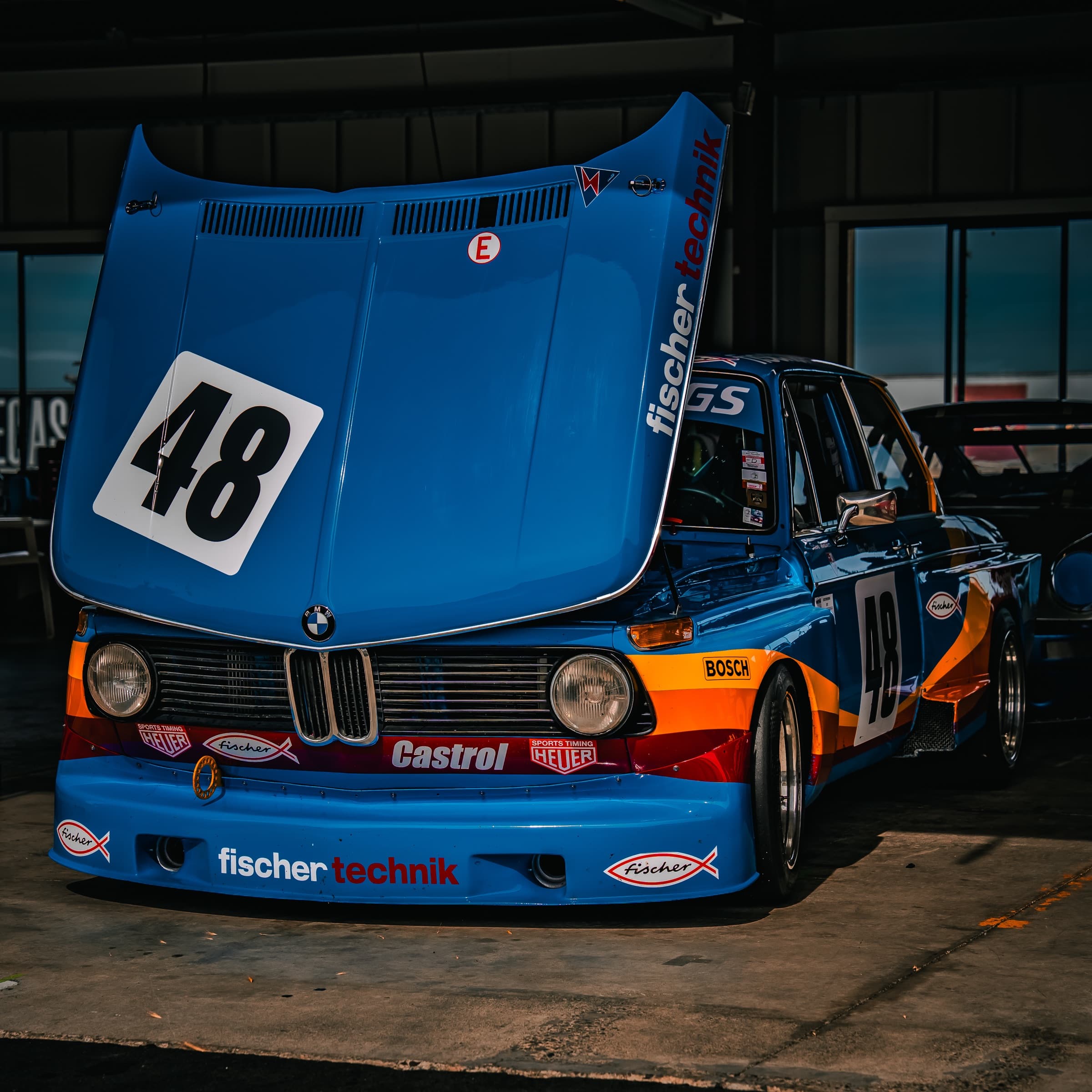 Fischer BMW 2002 with hood raised in the garage