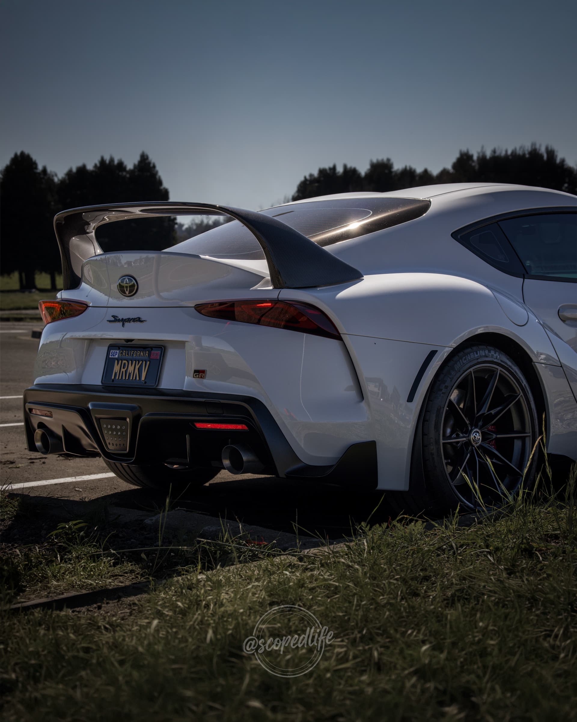 White Toyota GR Supra rear quarter at golden hour